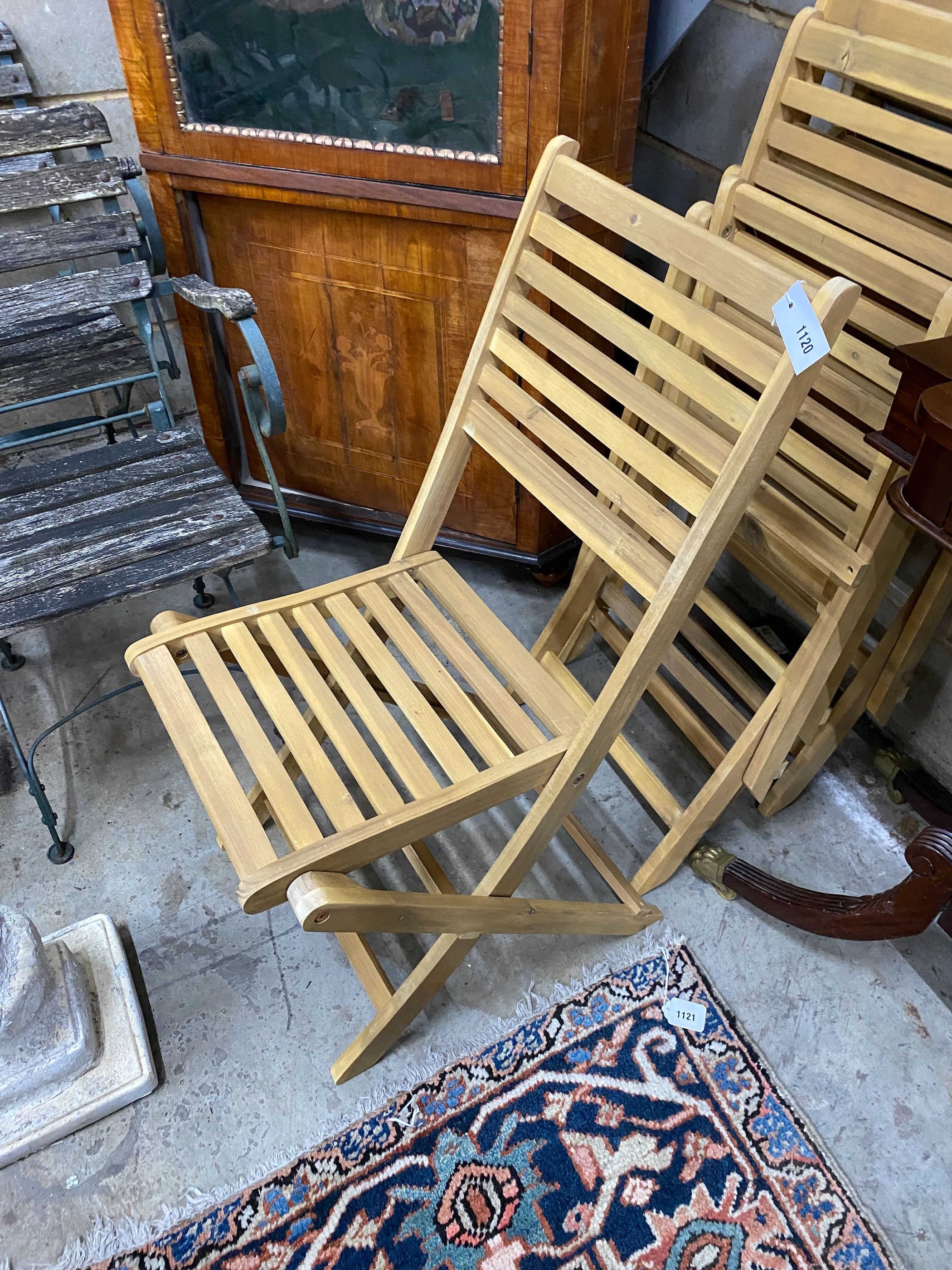 A set of four slatted wood folding garden chairs